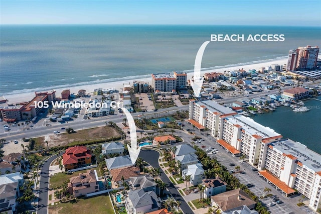 birds eye view of property featuring a water view and a view of the beach