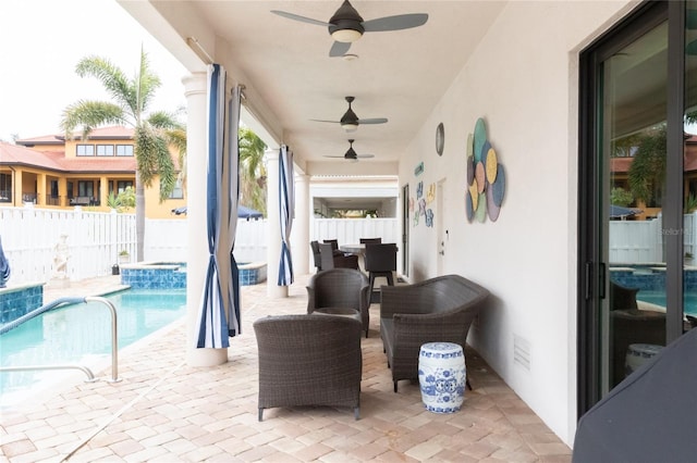 view of patio with a fenced in pool and ceiling fan