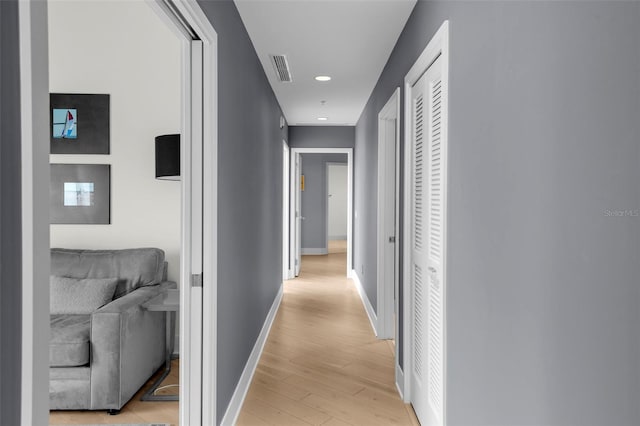 corridor with light hardwood / wood-style flooring