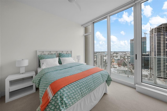 carpeted bedroom featuring access to exterior and floor to ceiling windows