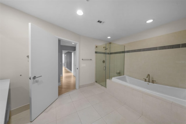 bathroom with tile patterned flooring and plus walk in shower