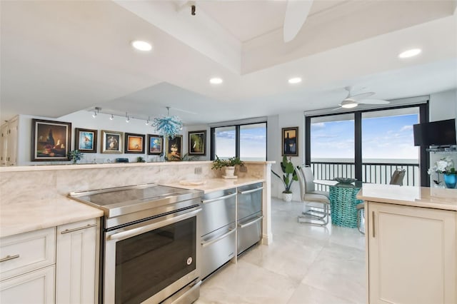 kitchen with stainless steel electric stove, a ceiling fan, and recessed lighting