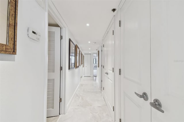 corridor with marble finish floor, recessed lighting, and baseboards