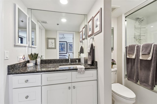 ensuite bathroom with ensuite bathroom, vanity, a shower with door, and visible vents