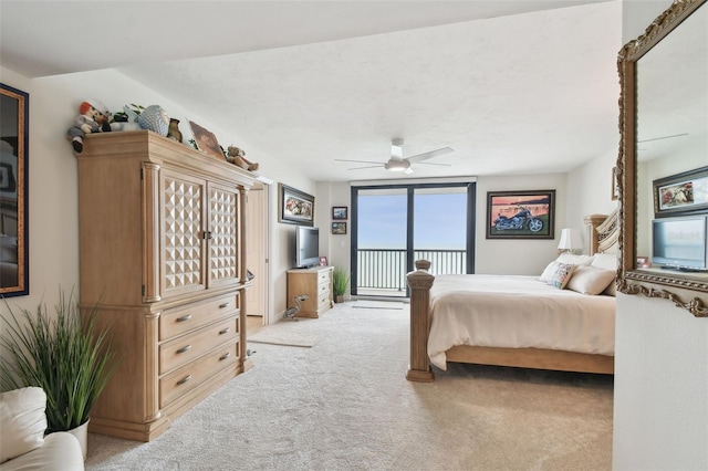 bedroom with ceiling fan, access to outside, and light colored carpet