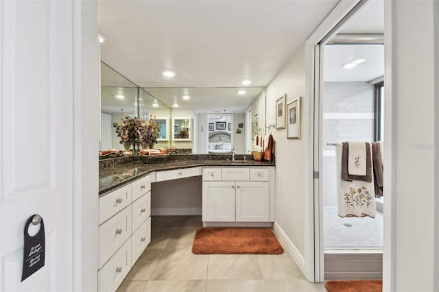 bathroom featuring a stall shower, baseboards, tile patterned floors, vanity, and recessed lighting