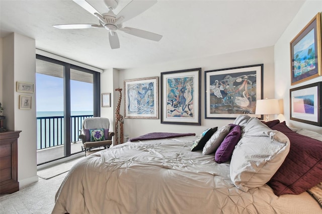 bedroom featuring ceiling fan, a water view, carpet flooring, access to outside, and expansive windows