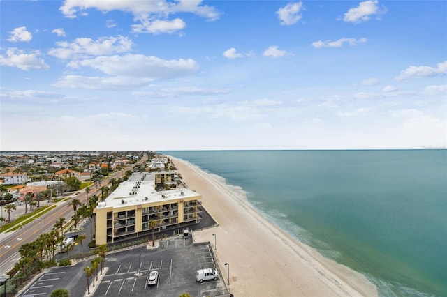 birds eye view of property with a water view and a beach view