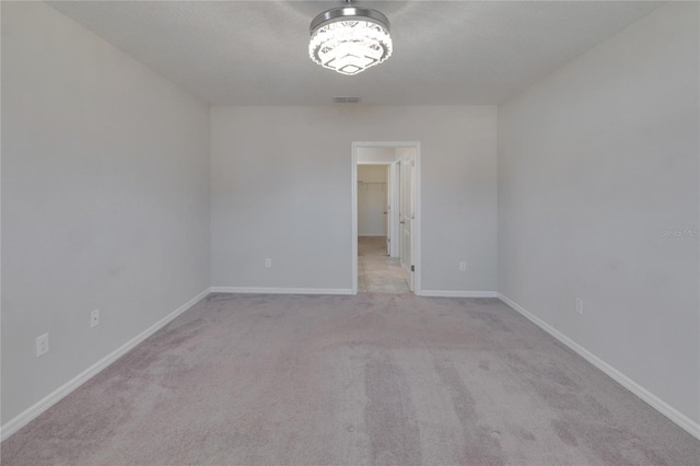 spare room with light colored carpet