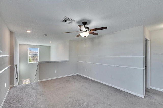 carpeted empty room with a textured ceiling and ceiling fan