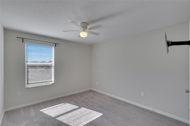 empty room with light carpet, a textured ceiling, and ceiling fan