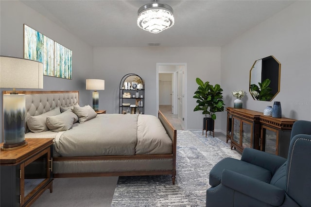 carpeted bedroom featuring visible vents