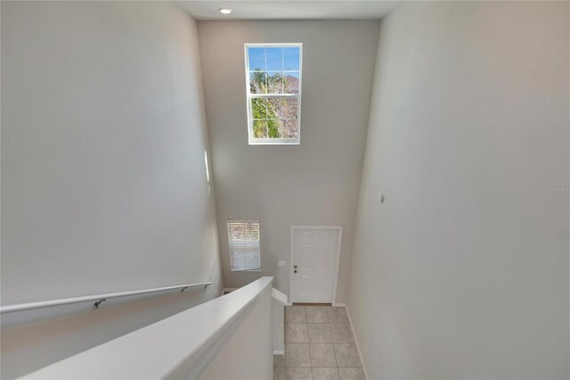 staircase with tile patterned flooring and baseboards