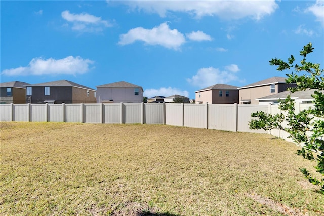 view of yard featuring a residential view and fence