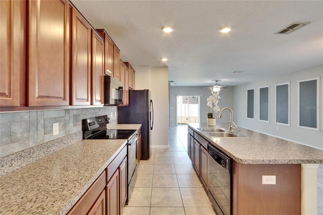 kitchen featuring a kitchen island with sink, range with electric stovetop, a sink, visible vents, and black dishwasher