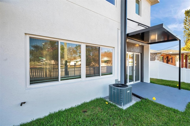 back of house with a patio area and central AC