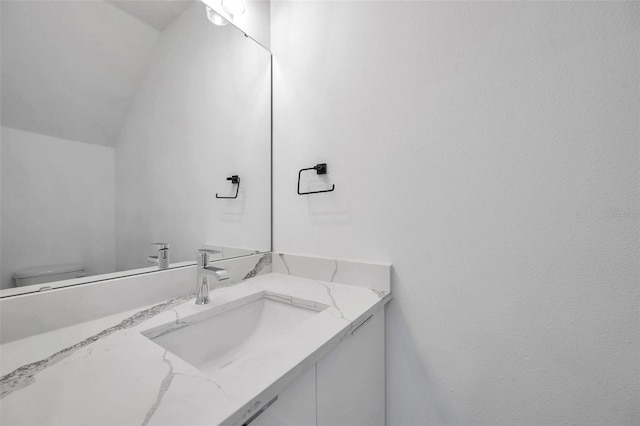 bathroom featuring toilet and vanity