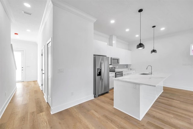 kitchen with stainless steel appliances, hanging light fixtures, crown molding, white cabinets, and sink