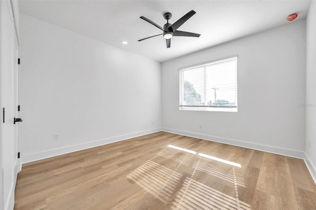 spare room featuring ceiling fan and light hardwood / wood-style flooring