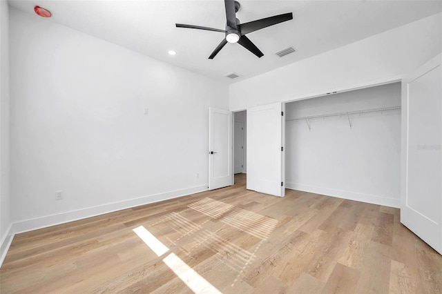 unfurnished bedroom with ceiling fan, a closet, and light hardwood / wood-style flooring