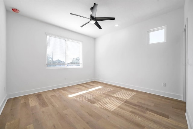 empty room with light wood-type flooring, ceiling fan, and plenty of natural light