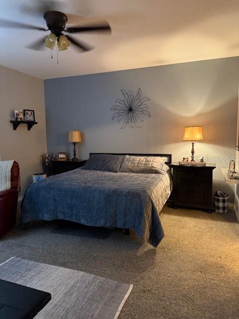 carpeted bedroom featuring ceiling fan