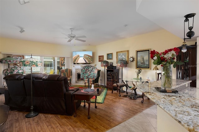 living room featuring light hardwood / wood-style flooring and ceiling fan