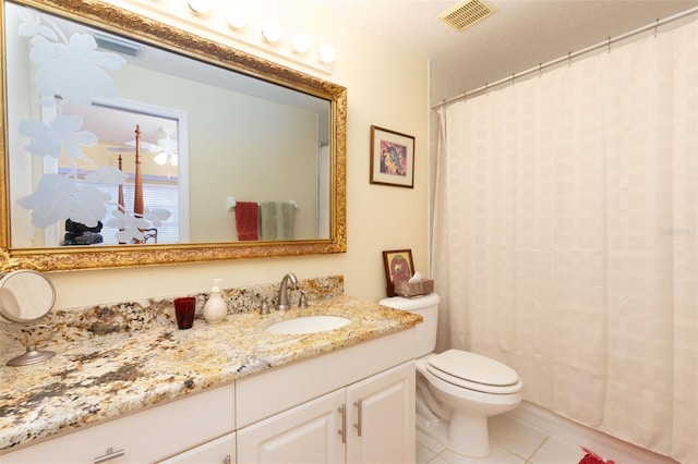 bathroom with vanity, toilet, and tile patterned flooring