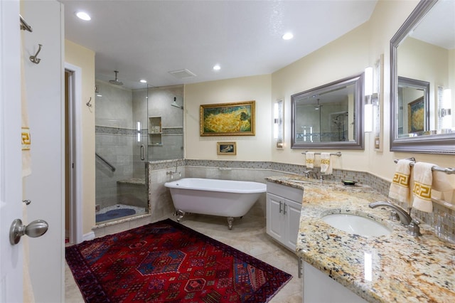 bathroom featuring tile patterned flooring, vanity, and separate shower and tub