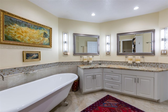 bathroom featuring vanity and a tub