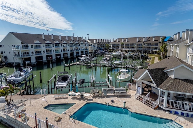 exterior space featuring a water view, a dock, and a community hot tub