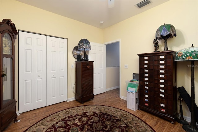 interior space with hardwood / wood-style floors, a closet, and ceiling fan