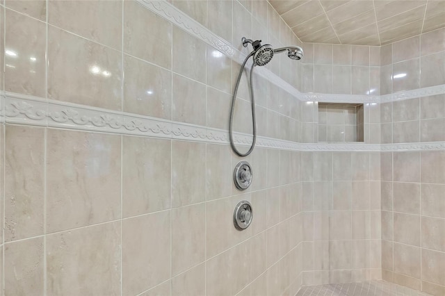 bathroom with tiled shower