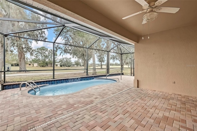 view of pool with a patio area and glass enclosure