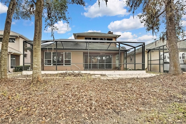 back of house featuring glass enclosure