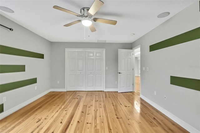 unfurnished bedroom featuring light wood-type flooring, ceiling fan, and a closet