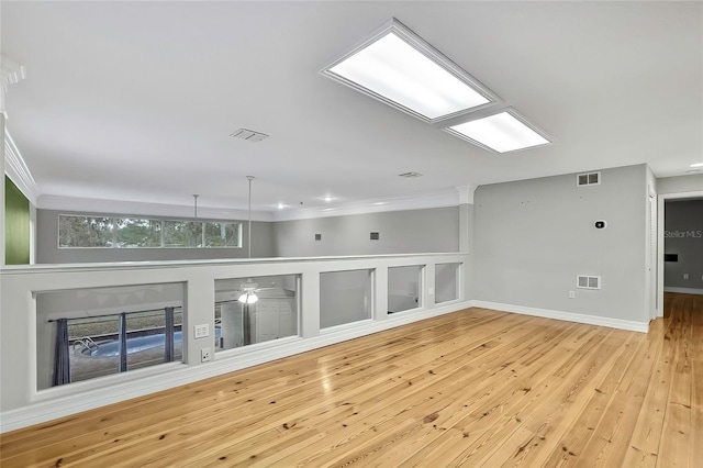 unfurnished living room featuring a fireplace and light hardwood / wood-style floors