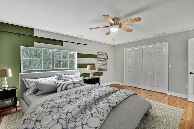 bedroom with a closet, ceiling fan, and wood-type flooring