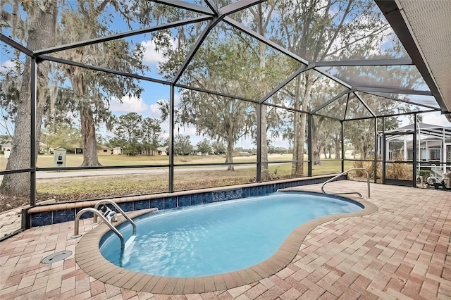 view of swimming pool with glass enclosure, pool water feature, and a patio
