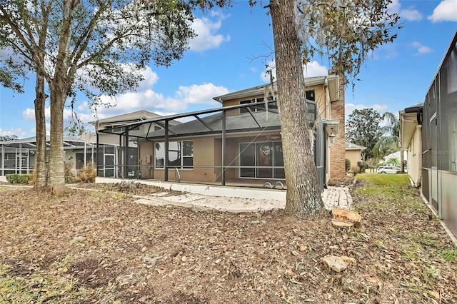 back of house with glass enclosure