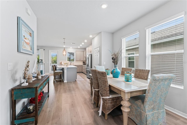 dining area with light hardwood / wood-style floors