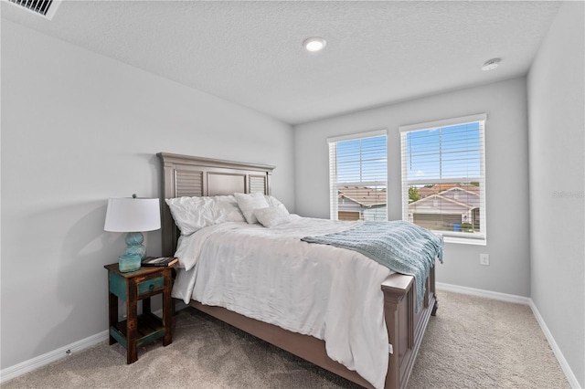 carpeted bedroom featuring a textured ceiling