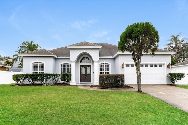 view of front of property featuring a garage and a front yard