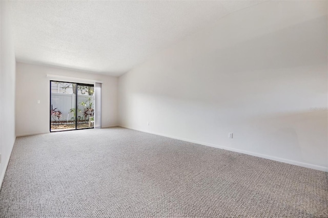 carpeted empty room featuring a textured ceiling and baseboards