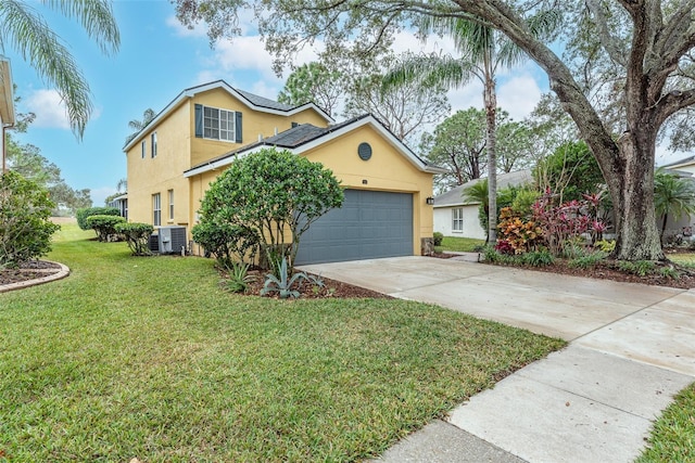 view of front of home featuring a garage, central AC unit, and a front lawn