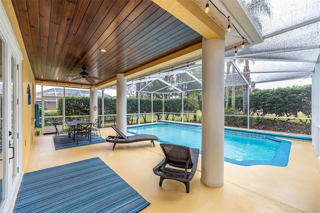 view of swimming pool with a patio area and a lanai