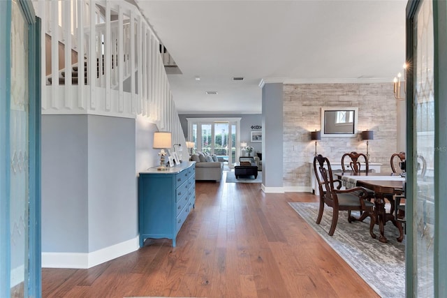 dining room featuring dark wood-type flooring and ornamental molding