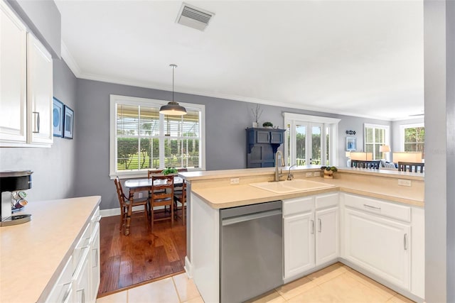 kitchen with dishwasher, white cabinetry, crown molding, and light tile patterned flooring