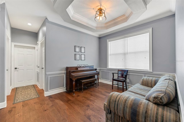 sitting room featuring crown molding, dark hardwood / wood-style floors, and a tray ceiling