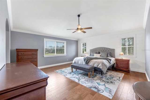 bedroom featuring ceiling fan, ornamental molding, and dark hardwood / wood-style floors